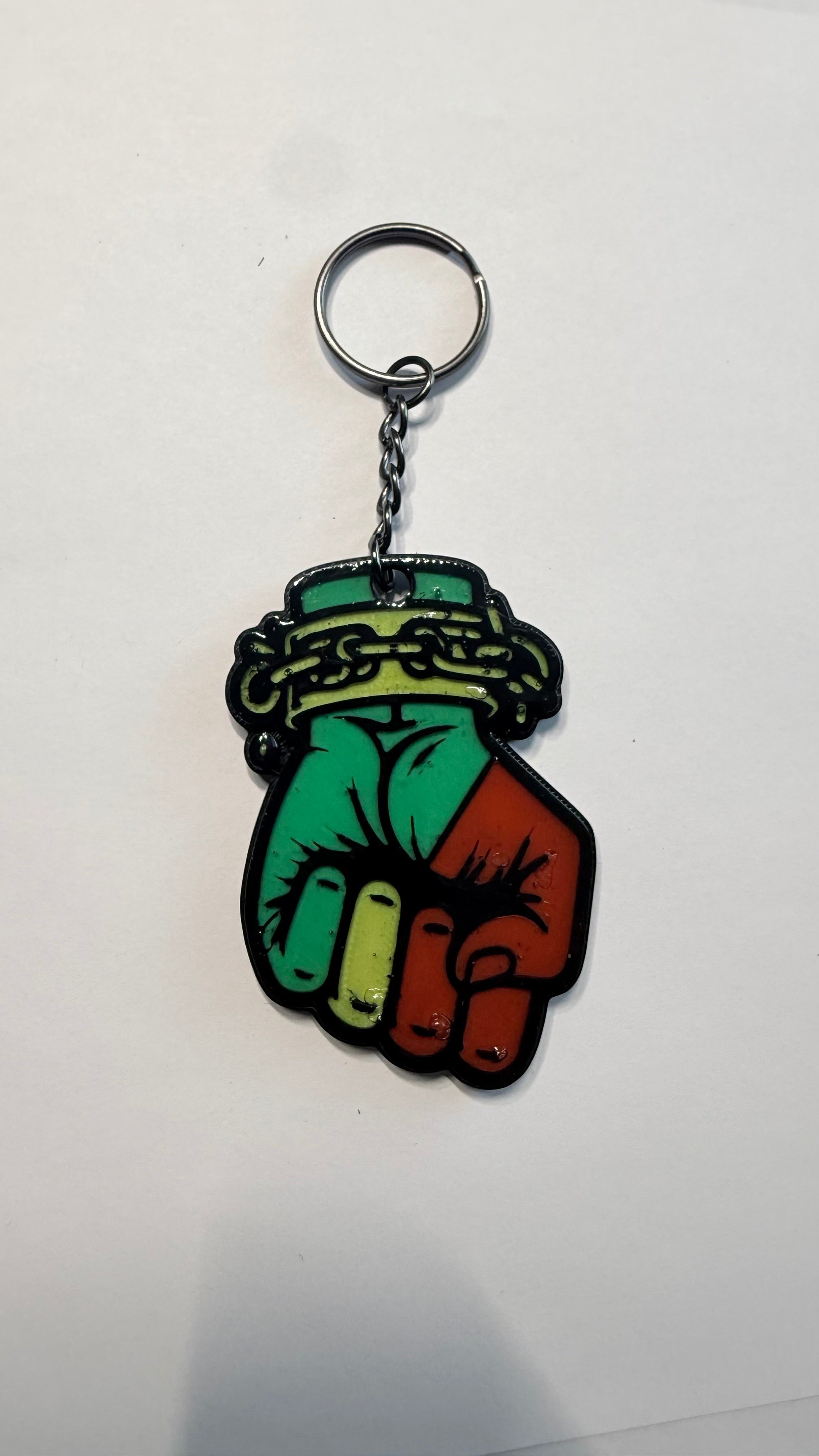 FLY-OG 3D Juneteenth keychain with a raised fist symbol in red, black, and green with broken chains.